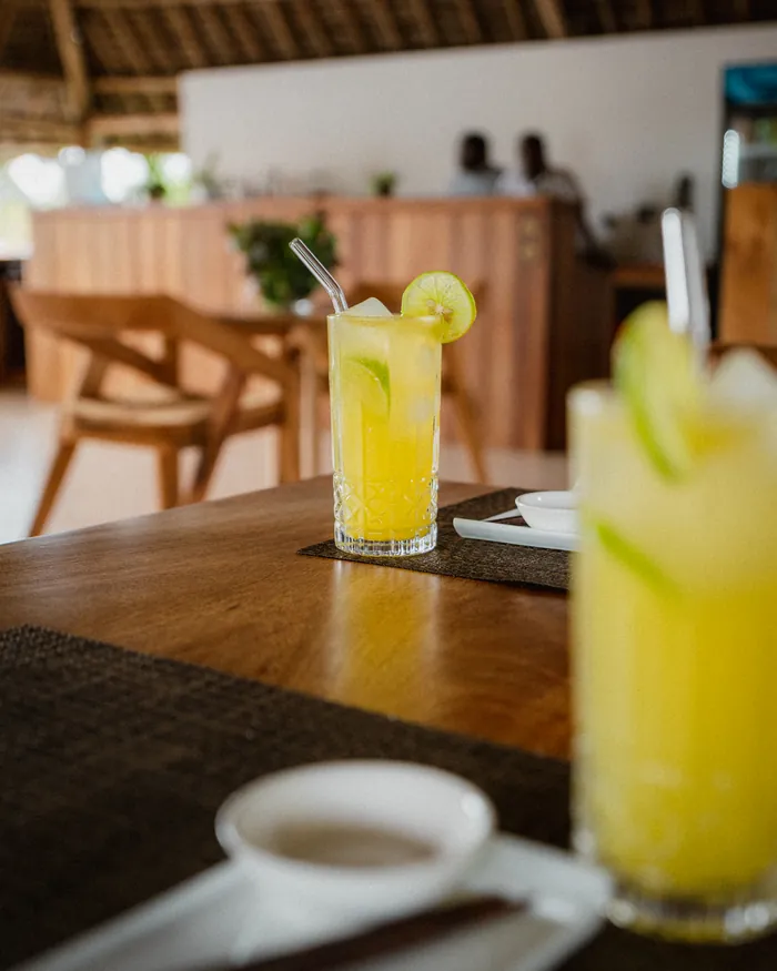 A fresh drink on the table, the KAMI bar behind it